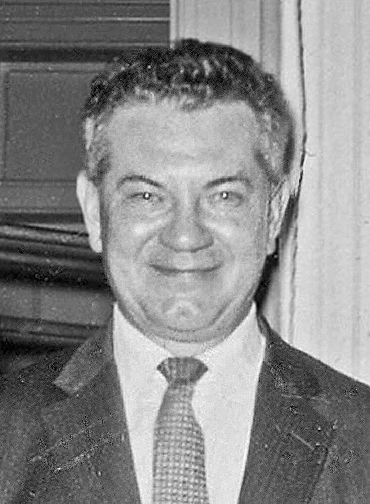A black and white photo of Binder smiling.