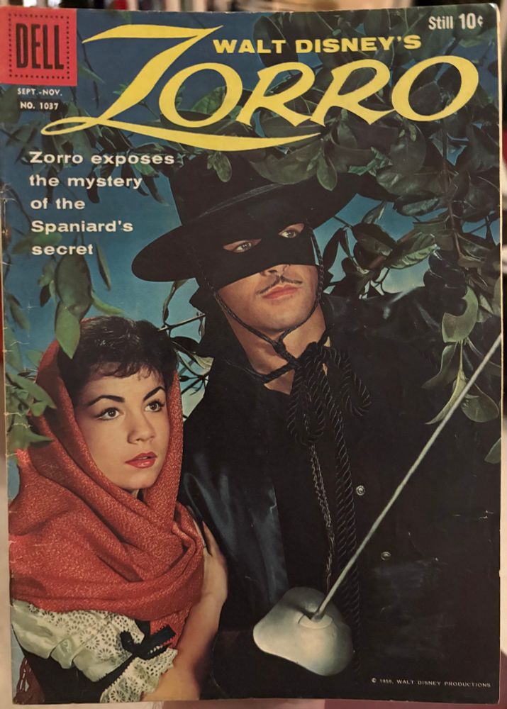 Four Color #1037 (1959), featuring Walt Disney's Zorro. The cover is a photograph of Guy Williams from the Disney tv show as Zorro standing next to a beautiful woman.