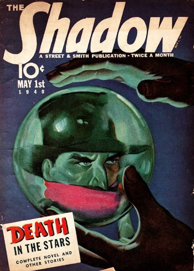 The cover shows a hand holding a crystal ball, which is revealing the face of the Shadow.