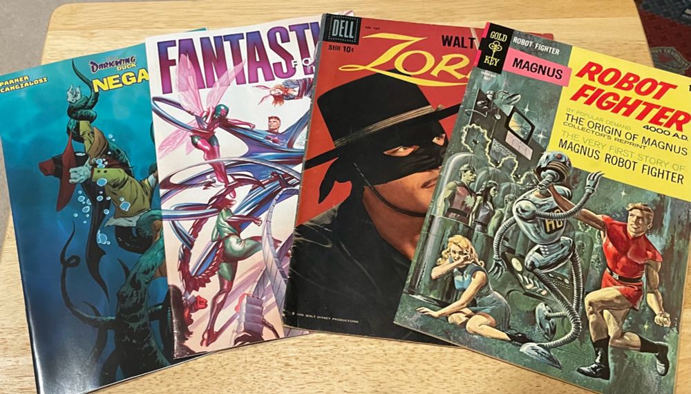 Four comic books-Darkwing Duck: Megaduck, Fantastic Four, Zorro, and Magnus: Robot Fighter.