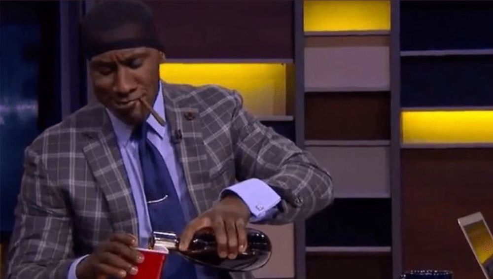 A meme of Shannon Sharpe pouring himself a drink