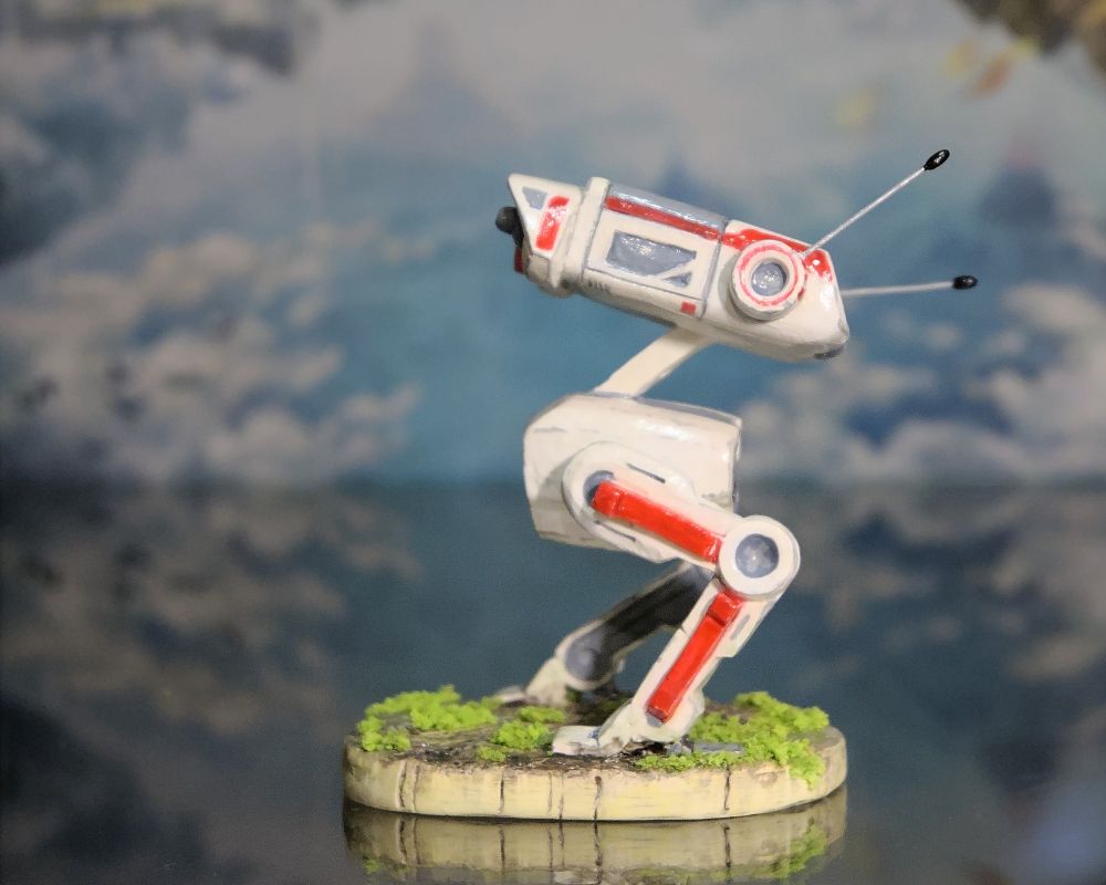 A small hand-painted Star Wars BD-1 robot made out of polymer clay. The figure is painted red and white with grey accents and a faux grass stand. Subsequent images show the figure from different angles.