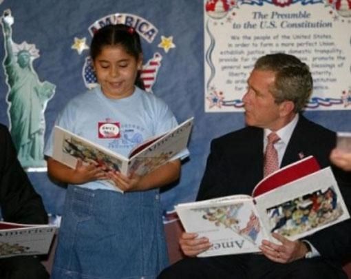 George Bush holding upside down book.