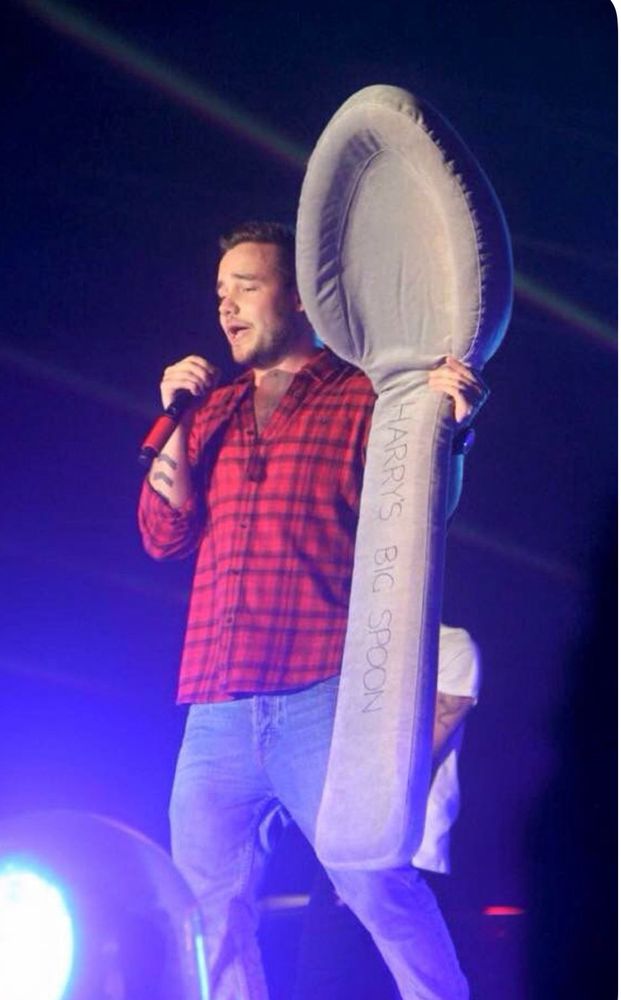 Liam Payne holding a giant spoon. 