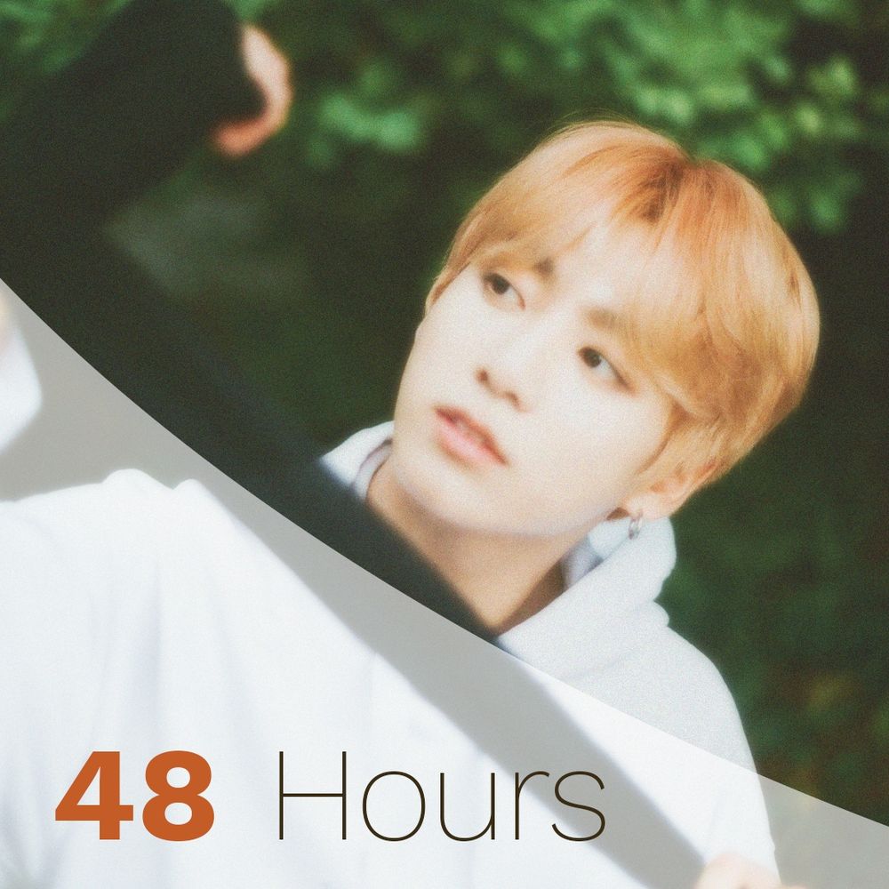 JK with strawberry blond hair and a white hoodie glanding to the left. The photo has a soft filter applied and says the words 