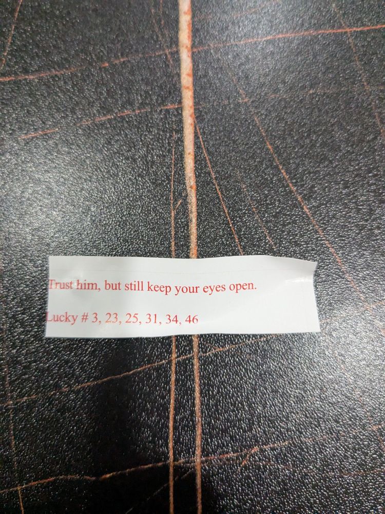 Fortune cookie fortune with text "trust him, but still keep your eyes open"