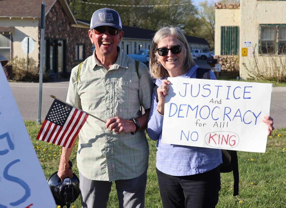 Man and woman
Man with small flag and megaphone
Woman with Justice and Democracy for All, No King sign