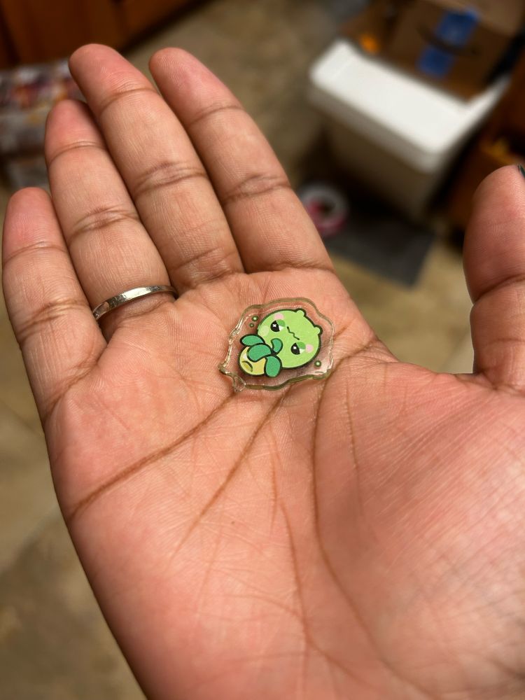 my poor smoliv phone charm laying broken in the palm of my hand, the plastic loop snapped off. it cannot be fixed.