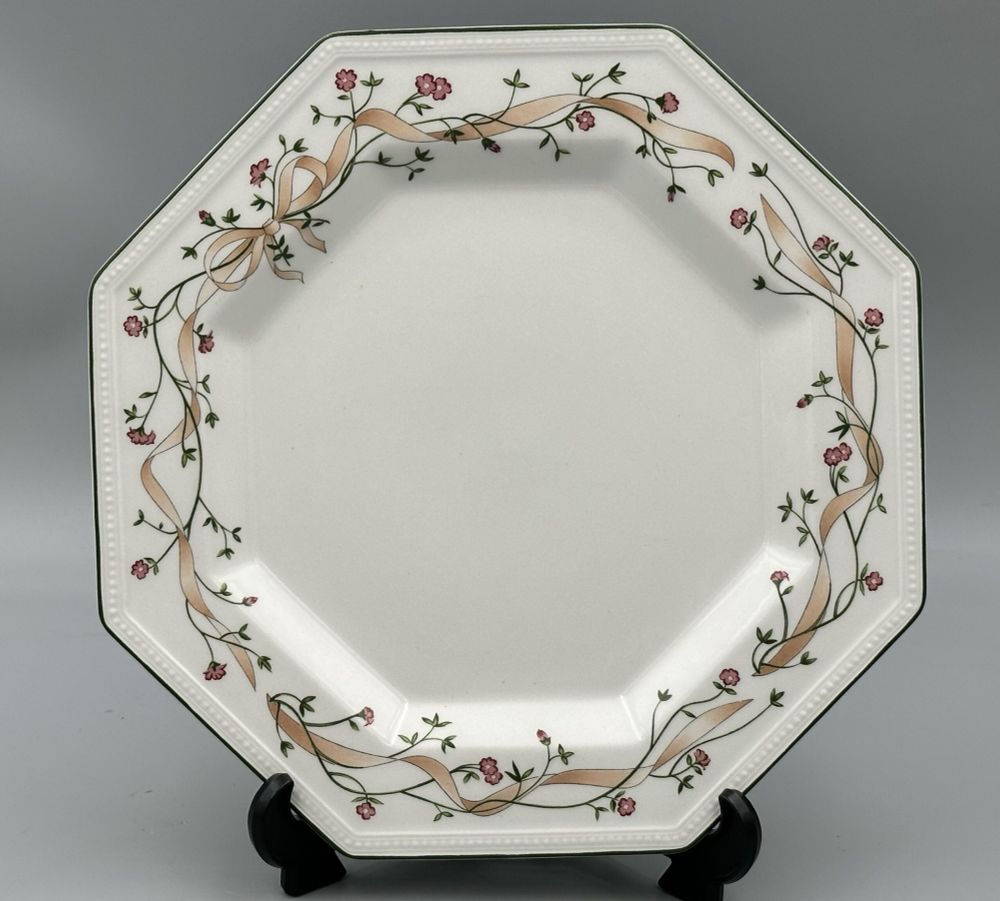 1980’s Octagonal shaped white plate with a border of pastel pink ribbons and dark green stems with reddish stylised flowers. The design was called Eternal Beau