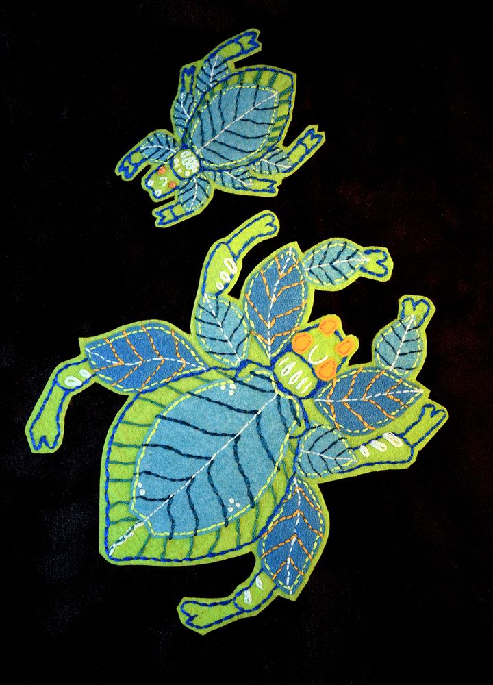 A picture of a couple of leaf bug embroidered patches, they are color green and on a black back ground, this little dudes are still available