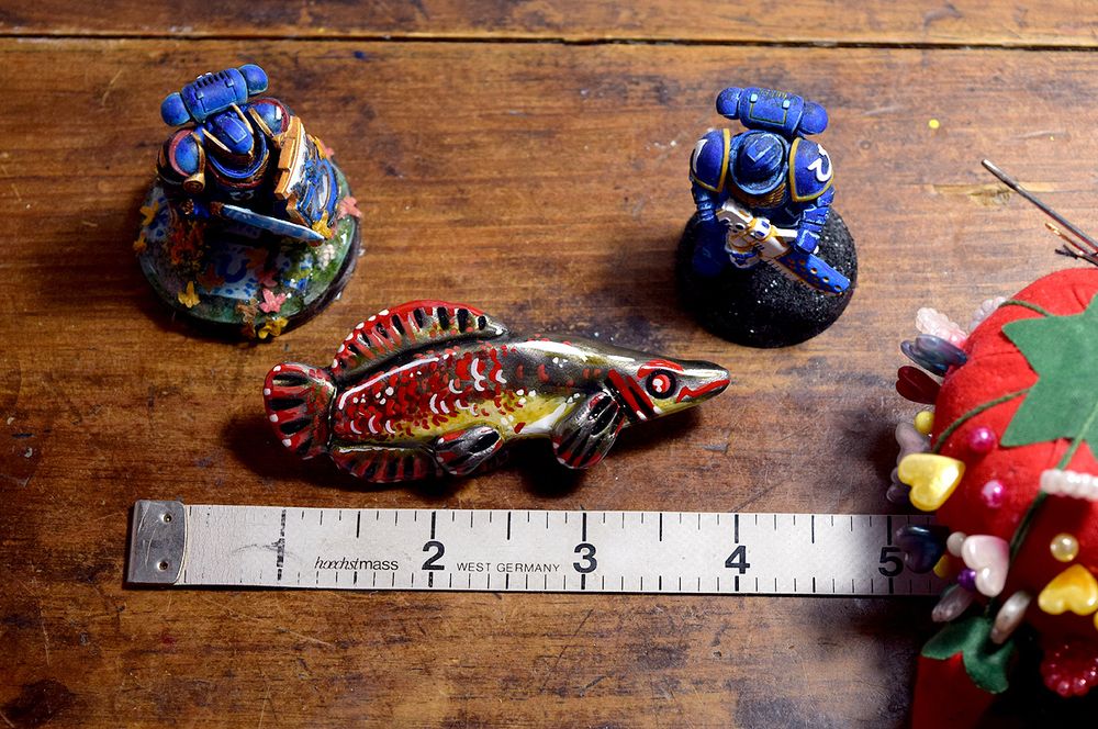 A scale pic of an arapaima polymer clay pin, Space marines also for scale lol