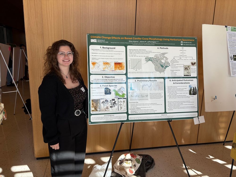 Masters student standing in front of a research poster.