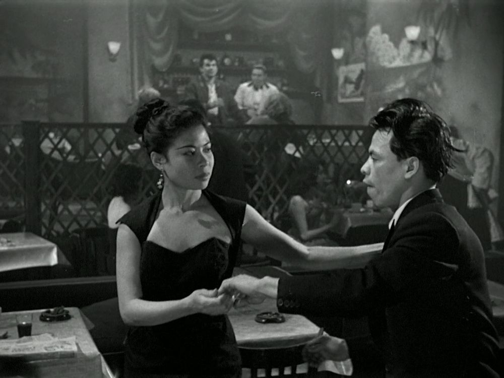 Two very cool patrons dance, both of whom are asian.