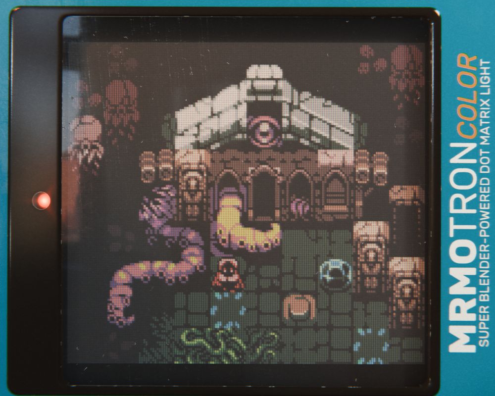3D render of what appears to be a vintage LCD display showing a building with tentacles and an eye.