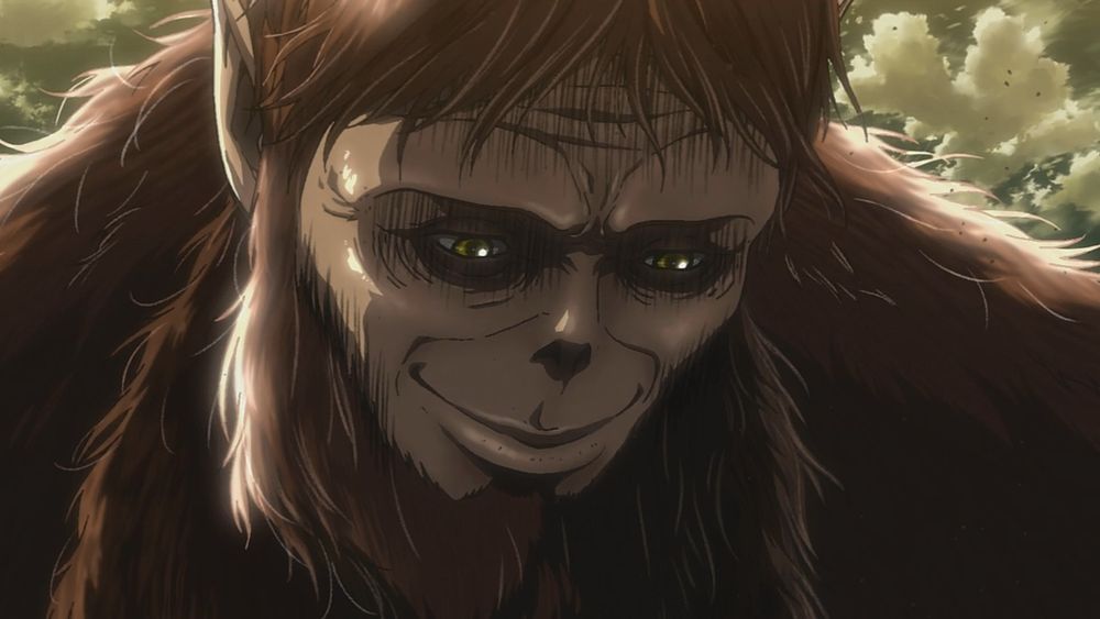 Still from the anime Attack on Titan showing Zeke in his beast titan form looking down and smiling serenly with clouds behind him