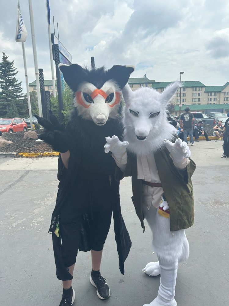 two fursuiters at a convention outside