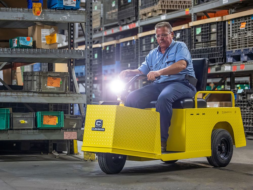 Stock photo of newer cushman minute miser. A 3 wheeled utility cart tricycle 