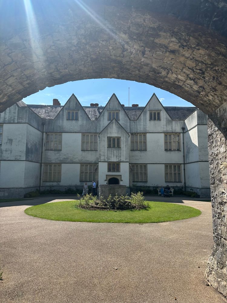 The entrance to St Fagans Castle. An imposing but plain façade, surrounded by an archway in front.