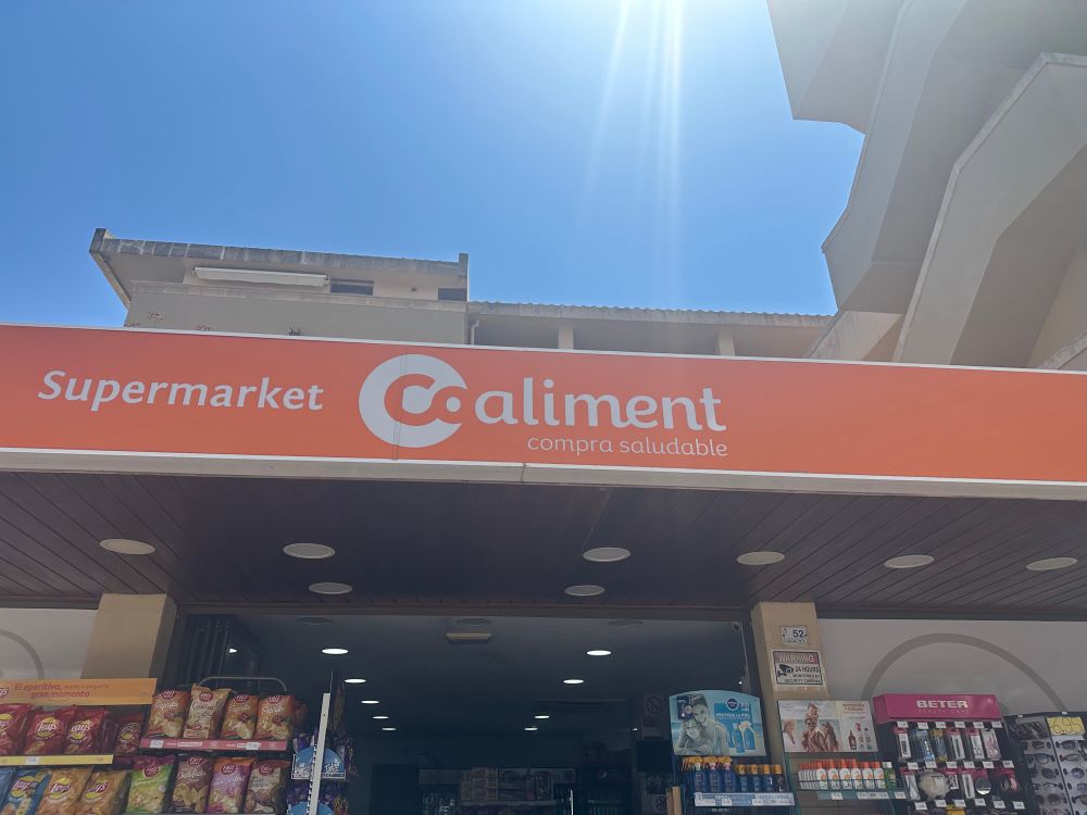 A supermarket shop front sign which reads: Supermarket Coaliment - compra saludable