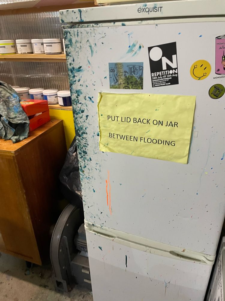 A white fridge with a bunch of fingerprints in dark ink