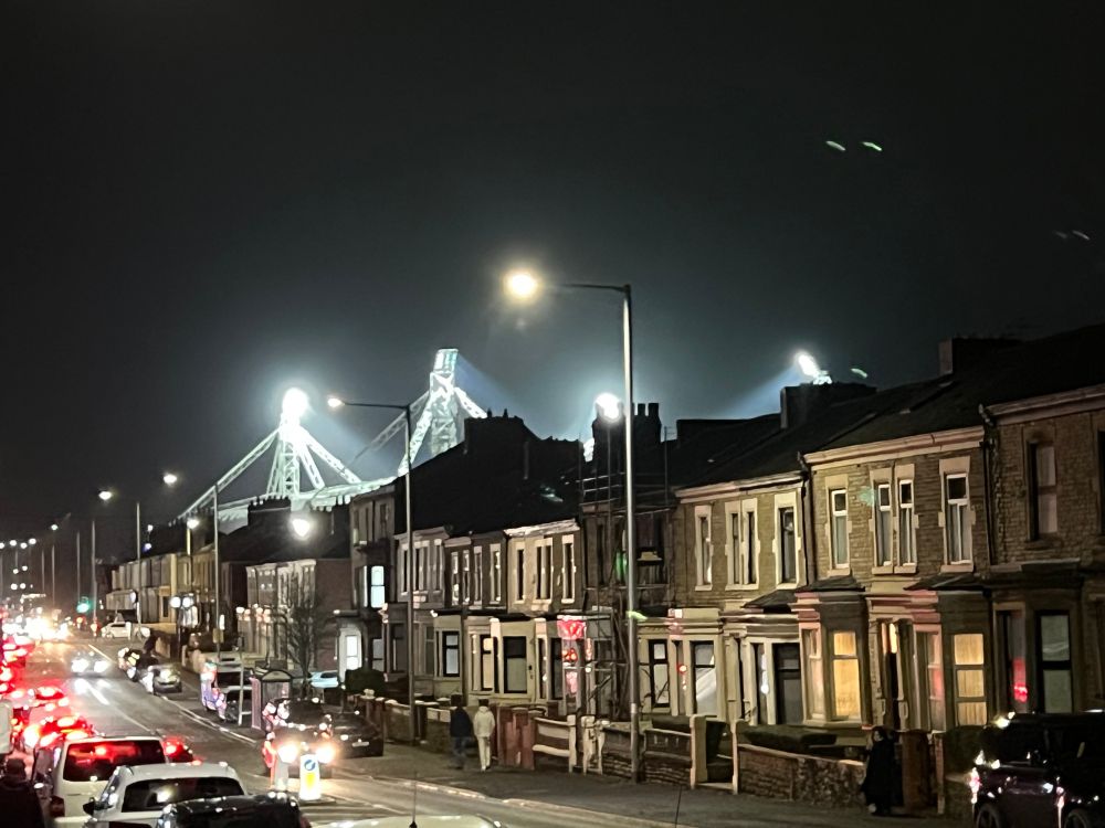 Floodlights close behind houses.