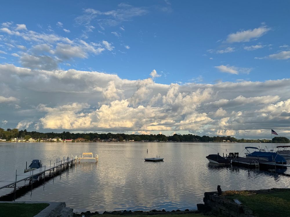 Sunrise showing a band of white clouds over a lake