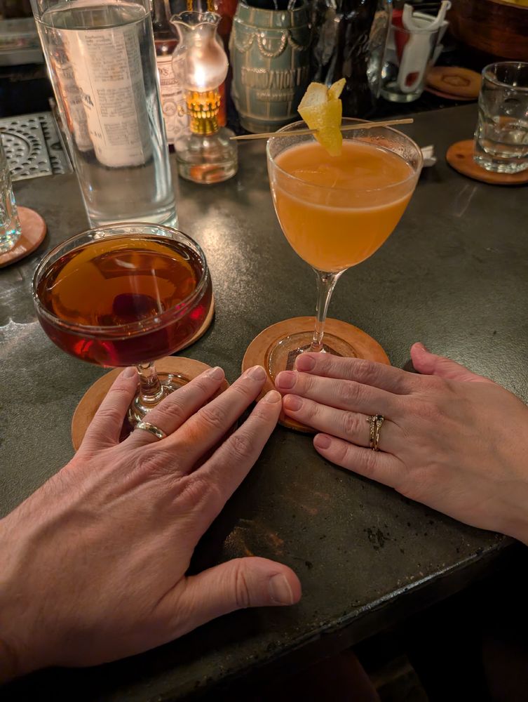 Shot of our drinks with our rings on our hands