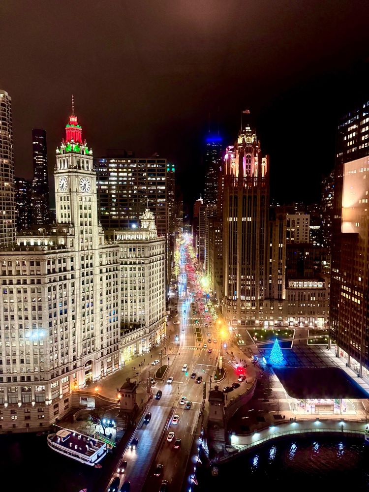 Photograph of Michigan Avenue looking east. Wrigley building to the left, tribune tower on the right. Chicago River in the foreground 