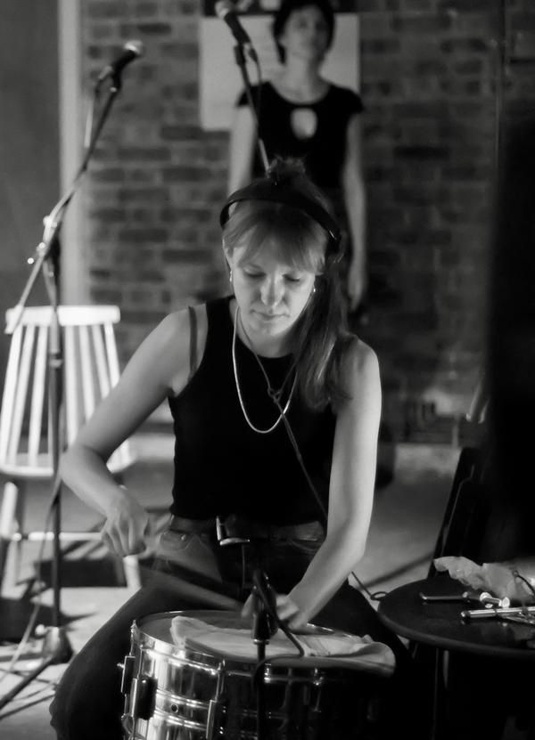 Black and white photo of Regan Bowering playing a snare drum. Photo by  Bradford Bailey