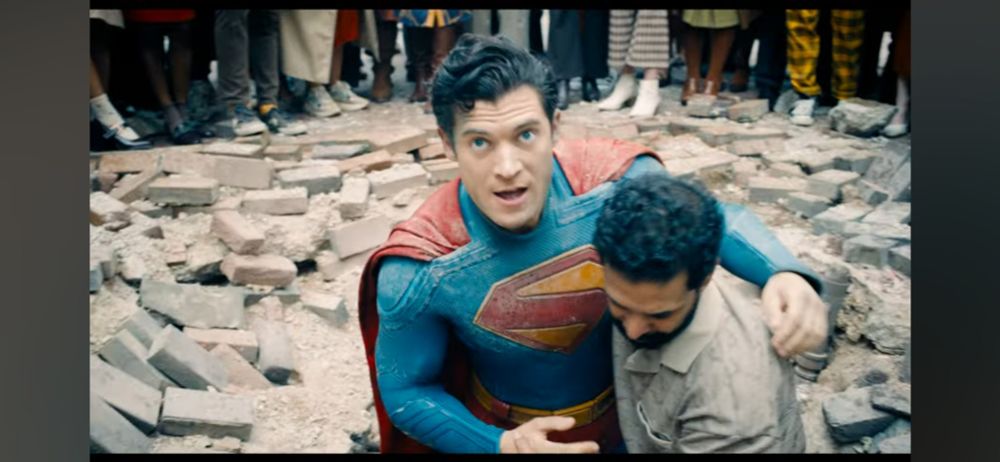 A human being helps an immigrant to his feet