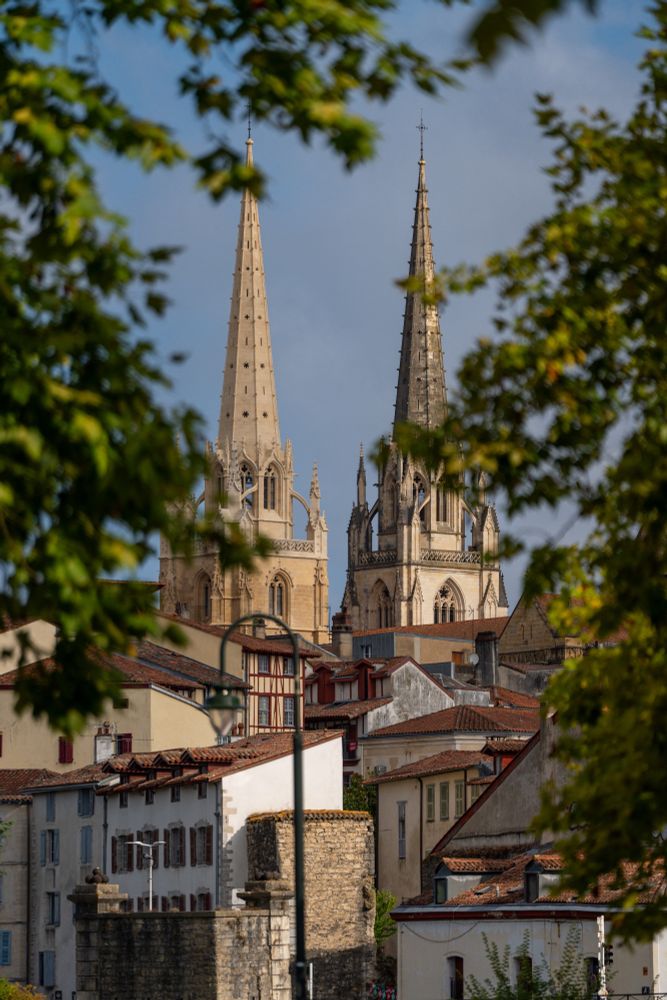 The two spires of Bayonne Cathedral. one has been cleaned; the other is waiting.