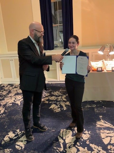 Bailey Chalmers accepting her 1st place award and describing her research.