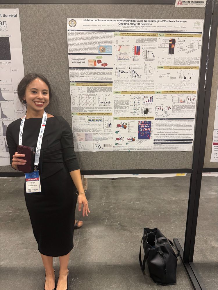 Ms. Megan Stasik wearing a black dress, standing in front of her poster presentation.
