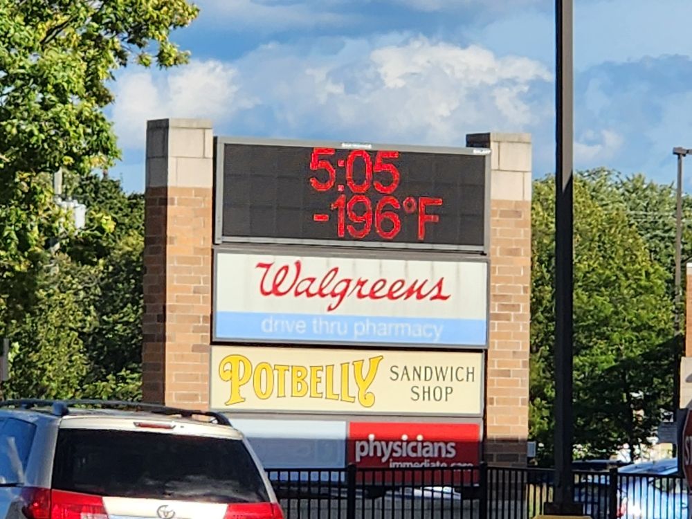 A sign outside a strip mall says it's 5:05PM and -196 degrees Farenheit