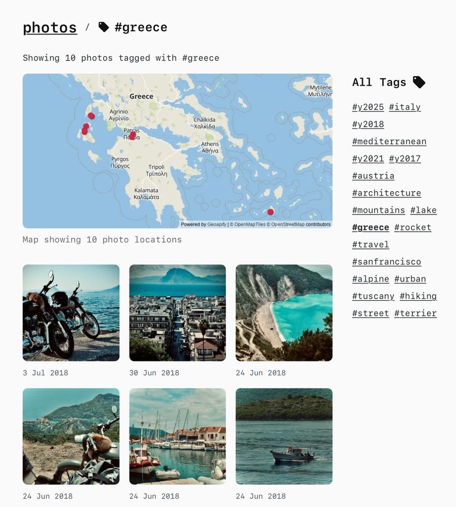 Photo gallery page showing 10 photos tagged with Greece, featuring a map of Greece with photo location markers and a grid of 6 travel photos including coastal scenes, motorcycles by the sea, village views, and boats in harbors, all taken in June-July 2018