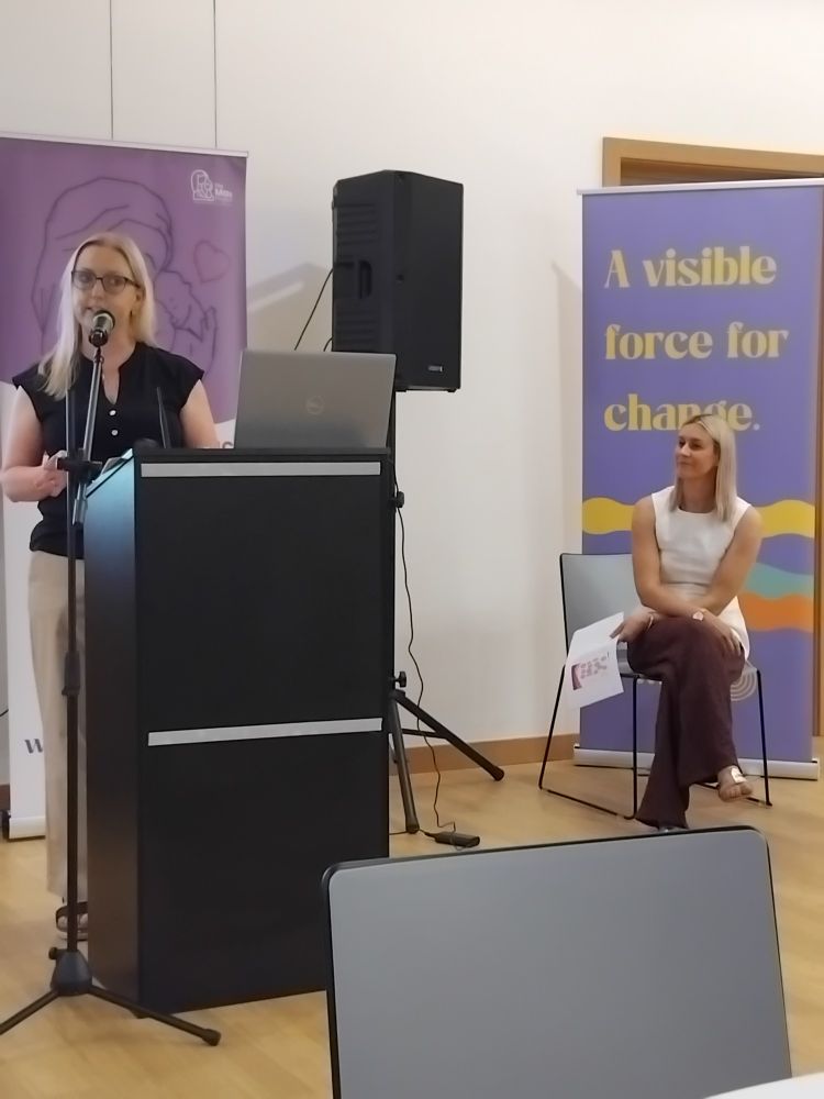 Clare Anderson speaking from a podium