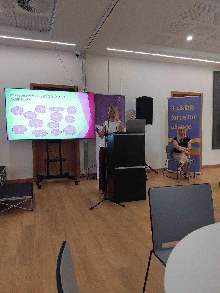 Jennifer Wright standing in front of a presentation. 