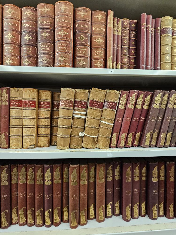 A picture of our collection of Punch magazine that dates from 1841 to the 1900s