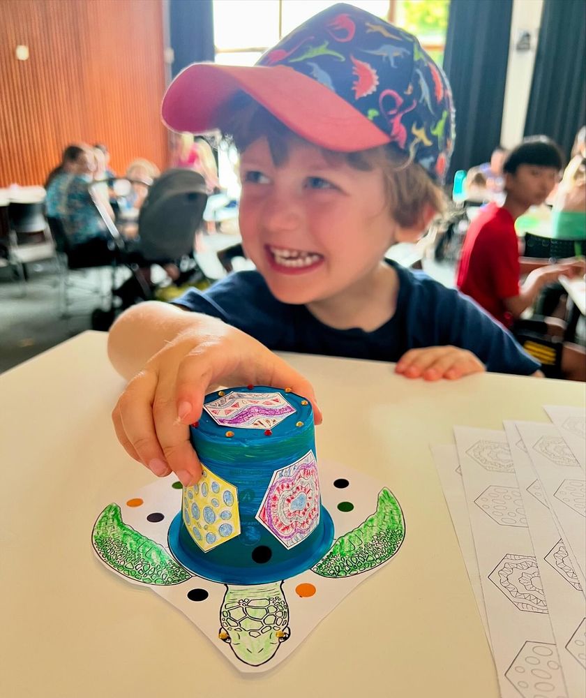A beautifully crafted turtle with it's cheerful creator (a little boy).