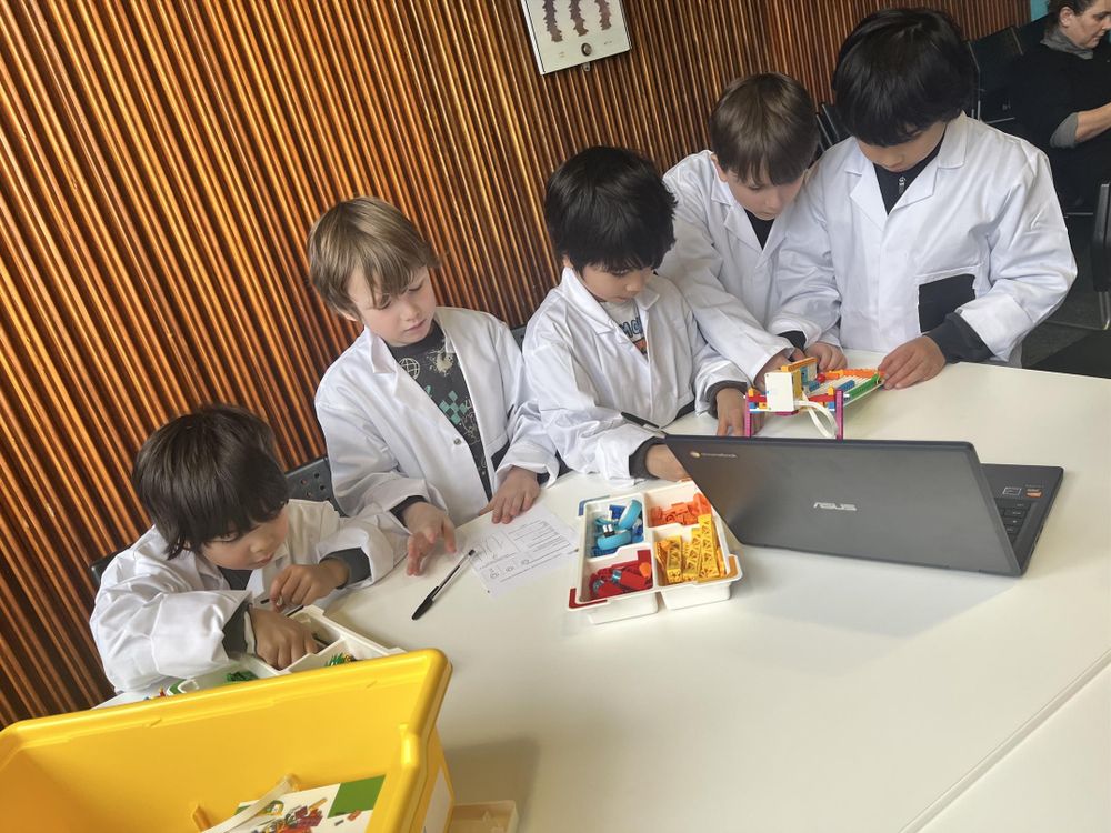 Kids building a Lego robot.