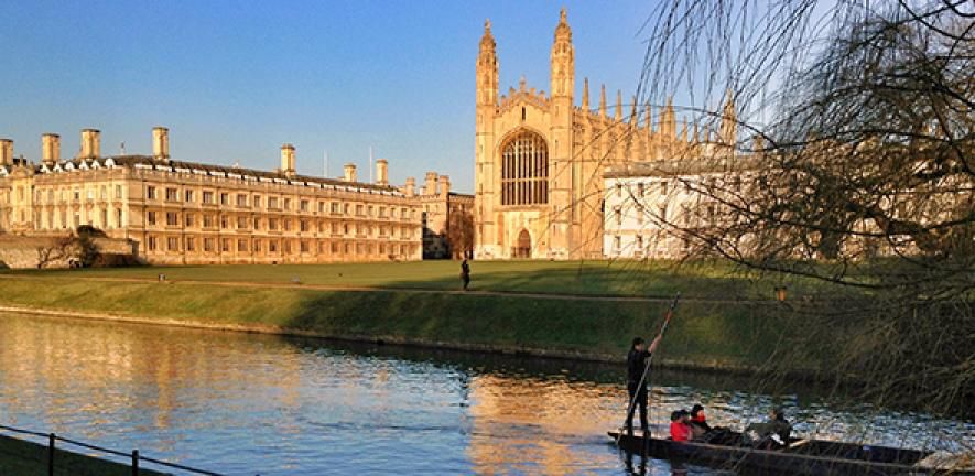 Photo of Cambridge River and view over King's College with a group of people punting.