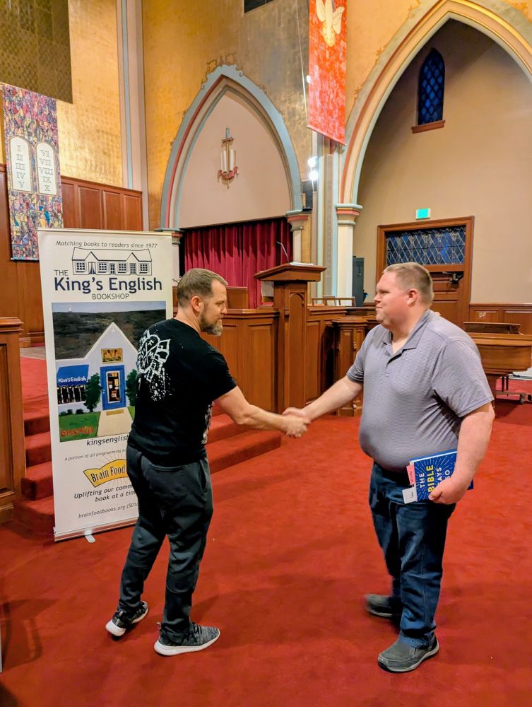 Noted Bible scholar Dan McClellan shaking hands with some rando in a church. 