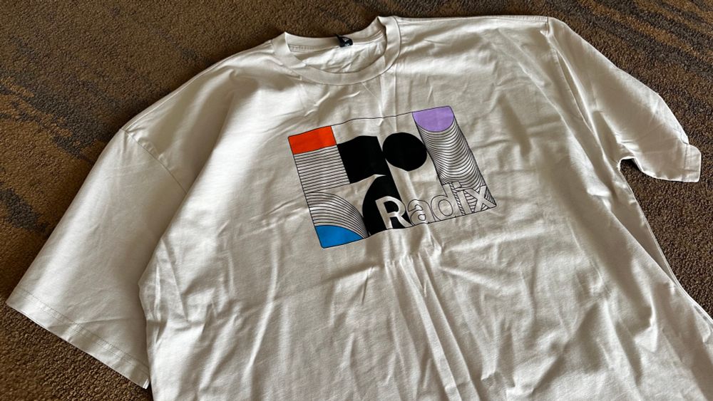 Off white T shirt with a retro-geometric design variation of the Radix UI logo.