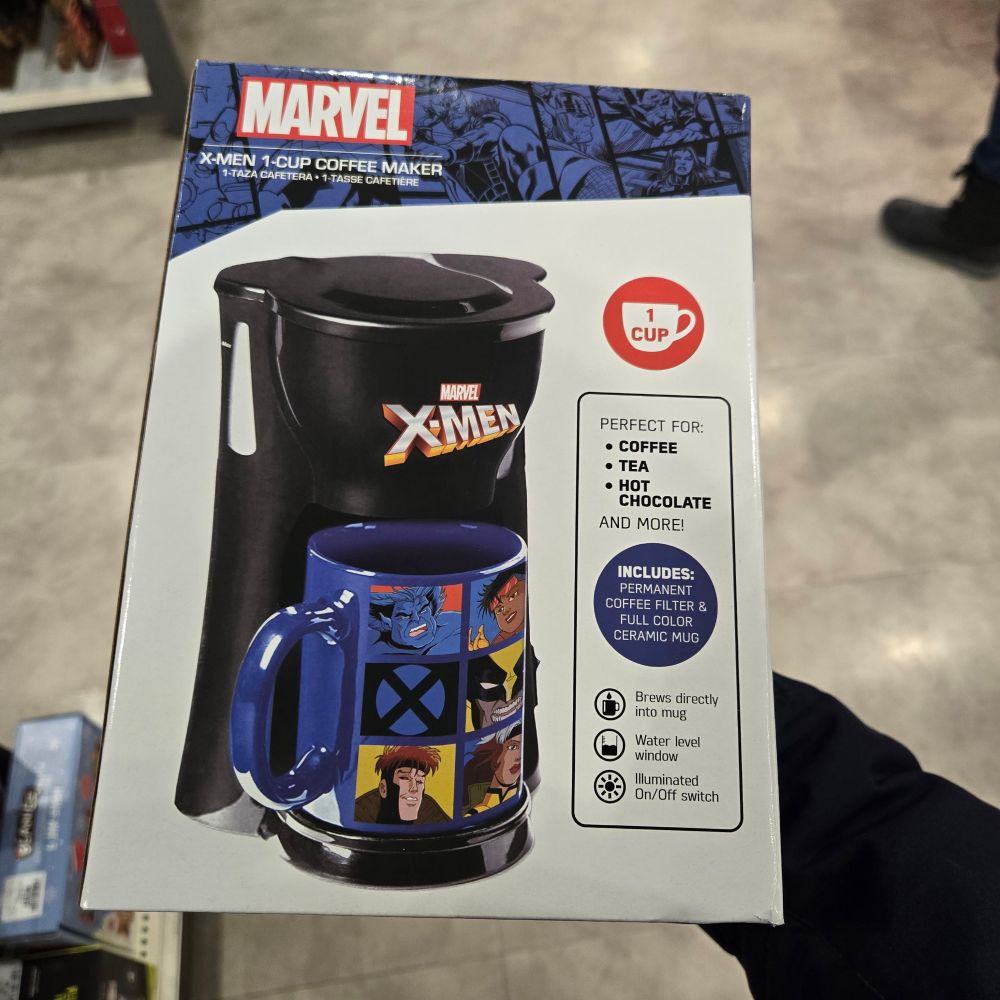 A single serve coffee maker, including mug. It's the X-Men theme, but the cartoon version from the 90s. Different X-men characters, including Gambit and Beast are on the mug.