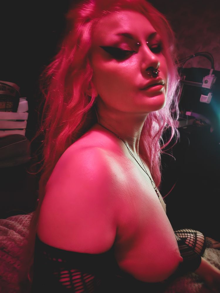 A dramatic portrait where my hair is dishevelled, and my skin looks like its glowing. Im looking a little over my shoulder with a sultry look on my face
