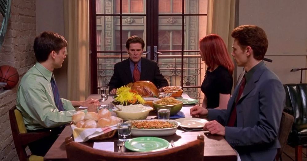 Tobey McGuire in Sam Raimi’s “Spider-Man” (2002) sitting with Willem Dafoe, Kirsten Dunst, and James Franco around a turkey with all the fixins