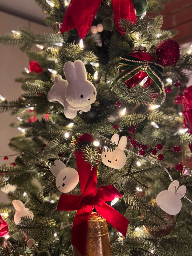a christmas tree with too many red bows and miffy bunnies