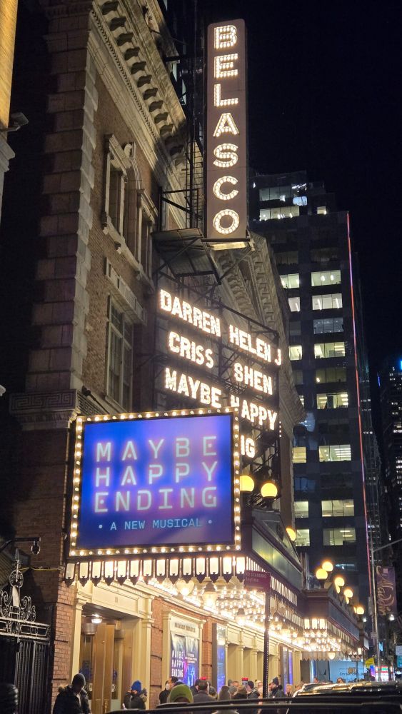 Marquee of the Belasco Theatre on Broadway, showing the name of the theater, the title of the show currently playing there, Maybe Happy Ending, and the names of its stars, Darren Criss and Helen J. Shen, in lights. Taken before this evening's show.