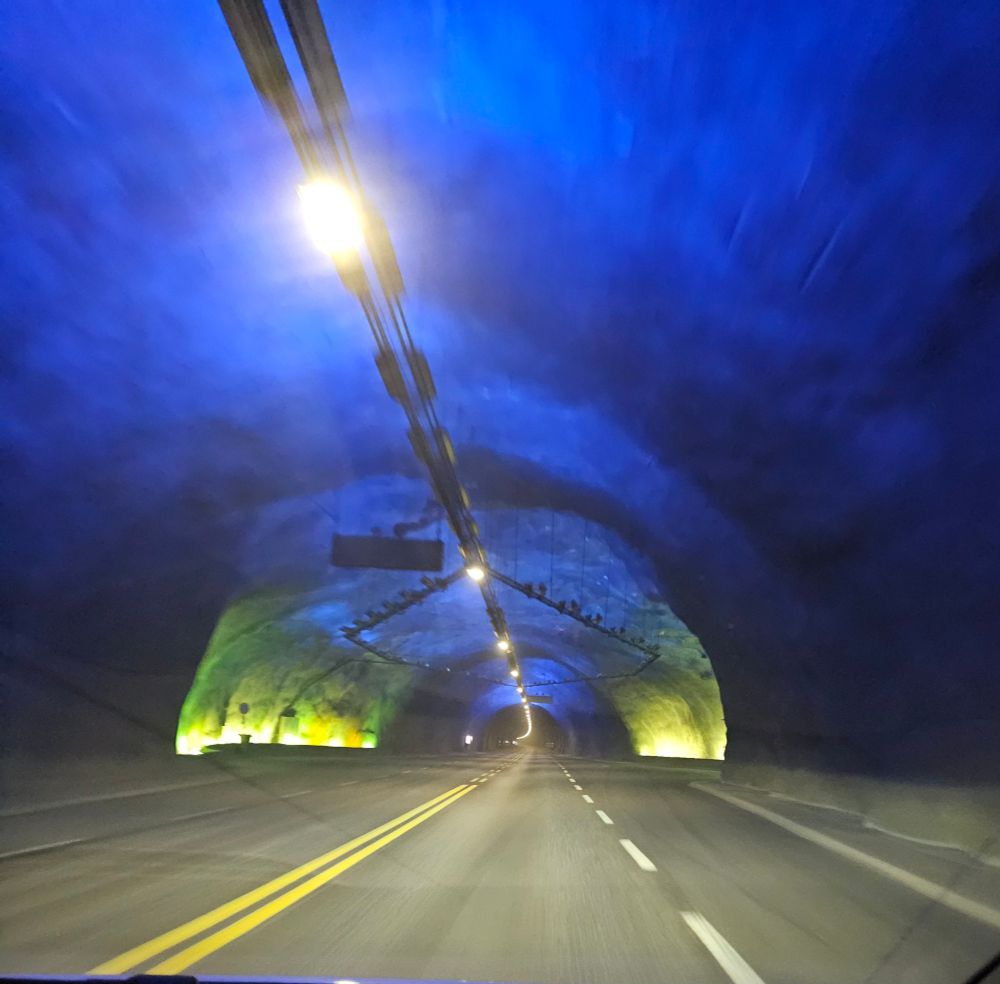 Blue light illuminates a cavern within the tunnel, one of three built to break up the monotony of the journey.