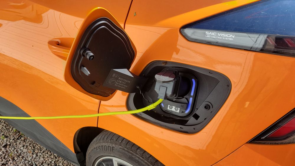 Extension cable plugged into the charging socket of an electric car